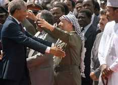 On his first trip to a foreign country after being released from prison, South African anti-apartheid leader and African National Congress (ANC) member Nelson Mandela (l), in Zambia to attend a meeting of the ANC National Executive Committeee, warmly greets PLO chairman Yasser Arafat on his arrival in Lusaka, Feb. 27, 1990. (Philip Littleton/AFP/Getty Images)