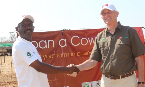 2  'Loan a Cow' beneficiary Chibombo farmer Gillard Shakete shaking hands with ZANACO CEO Bruce Dick