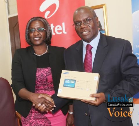 Airtel CEO Charity Chanda Lumpa and Zambia Open University Vice Chancellor Professor Mutale Musonda  showing off a tablet; Airtel and ZAOU have launched a  loan Scheme that will enable the ZOAU members of the Senate to acquire tablets that they will be paying monthly, the ceremony took place at ZOU senate boardroom off Mumbwa road in Lusaka West on Wednesday, September 24th,   2014.