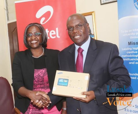Airtel CEO Charity Chanda Lumpa and Zambia Open University Vice Chancellor Professor Mutale Musonda  showing off a tablet; Airtel and ZAOU have launched a  loan Scheme that will enable the ZOAU members of the Senate to acquire tablets that they will be paying monthly, the ceremony took place at ZOU senate boardroom off Mumbwa road in Lusaka West on Wednesday, September 24th,   2014.