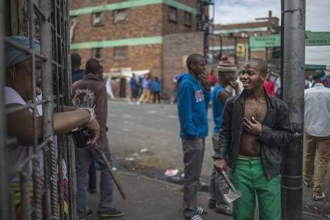An African immigrant holds a machete in a run-down district of east Johannesburg(Siphiwe Sibeko:Reuters)