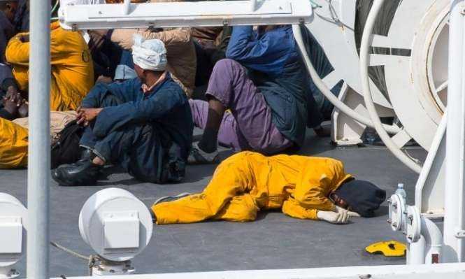 A survivor sleeps on the deck of the Italian coastguard vessel Bruno Gregoretti in the Maltese port of Senglea. Photograph- Ian Pace:Demotix:Corbis