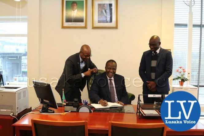 Finance Minister hon Felix Mutati smiles after signing the Visitors Book at the Embassy of Zambia in Stockholm, Sweden  n_a
