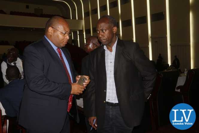FAZ GS Ponga Liwewe having a chat with Football veteran administrator com coach Patrick Kangwa.