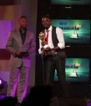 Former Zambian soap opera Kabanana actor Kangwa Chileshe presents the best producer award to Ben Blazer of the