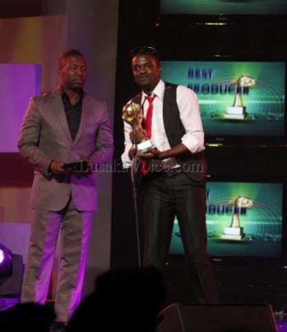 Former Zambian soap opera Kabanana actor Kangwa Chileshe presents the best producer award to Ben Blazer of the blazer studios