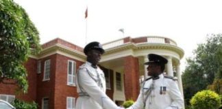 Dr Solomon Jere congratulates Lemmy Kajoba after his appointment and swearing in at State House as Police Commissioner for Muchinga Province