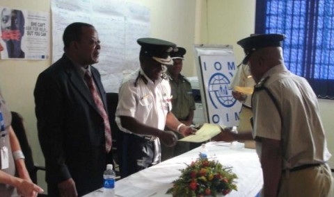 L-R Annie Lane, IOM Zambia Chief of Mission Dr Andrew Choga, Zambia Police Deputy Inspector General, Dr. Solomon Jere Handover of cerficates.Photo-Chris Price_0