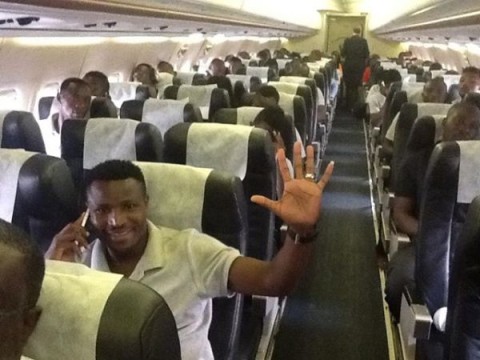 Skipper Chris Katongo gives a wave of confidence as the Chipolopolo settle into their charter aircraft for the flight to Kumasi.