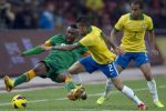 Brazil – Daniel Alves, centre, and Lucas Silva, right, compete for the ball against Zambia – Mayuka Emmanuel during a friendly match held at the Bird – Nest national stadium in Beijing, China, Tuesday, Oct. 15, 2013