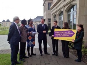 Monday 17th June, before the G8 officially began, L-R Ben Jackson - CEO for Bond and IF Chairman,Baaba Maal - a singer from Senegal, Pamela Chisanga - Action Aid's Zambian Country Director and Melissa and Lorcan - two school children from Enniskillen, hand the UK Prime Minister a letter on the behalf of 1.4 million people detailing our common goal.