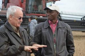 Kelvin Kamfwa, right, talks with Iowa farmer Ron Heck during a World Food Prize tour.