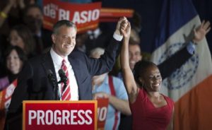Liberal Democrat Bill de Blasio ( holding His wife's hand) cruised to victory on Tuesday in the race to succeed New York Mayor Michael Bloomberg, marking the first time a Democrat has captured City Hall in two decades