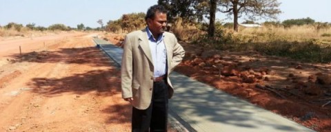 Resident Engineer inspecting concrete walkway 