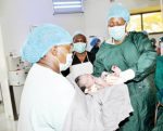 Taking charge of a life- First Lady Christine Kaseba (right) holds a baby after helping in the delivery at Choma General Hospital on Wednesday. – Picture by THOMAS NSAMA