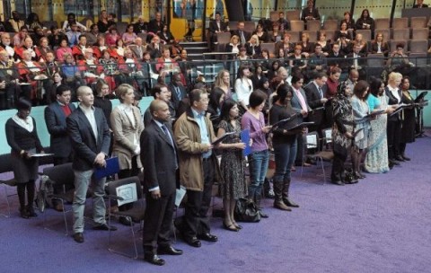 Immigrants to the United Kingdom take an oath before being presented with a certificate of citizenship by the London Mayor Boris Johnson at City Hall, London, on November 20, 2009