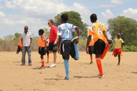 With Wilderness Safaris staff at Toka Leya, Zambia; Warming up for the final match at Jabulani School in Zimbabwe