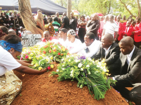 SPECIAL assistant to the President for press and public relations George Chella (centre) with his siblings laying wreaths during the burial of their late mother Loveness Sakanya Chella at Nkana East Cemetery in Kitwe yesterday. – Picture by JERRY MUNTHALI.