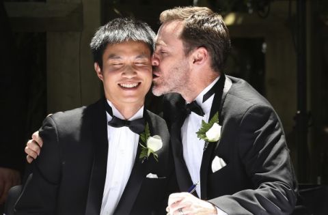 Ivan Hinton, right, gives his partner Chris Teoh a kiss after taking their wedding vows during a ceremony at Old Parliament House in Canberra, Australia, Saturday, Dec. 7, 2013. Dozens of same-sex couples from all around the country took advantage of the Australia Capital Territory's new law allowing same-sex marriages. But the unions will be short lived: The High Court overturned the law on Thursday, Dec. 12, 2013.