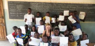 Emily McKeone, a Peace Corps volunteer and University of Nebraska-Lincoln graduate, poses with students of a rural school in the Luapala province of Zambia. McKeone is raising money to build three wells for three local schools in Zambia
