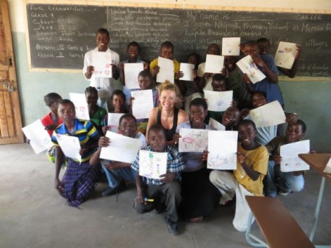 Emily McKeone, a Peace Corps volunteer and University of Nebraska-Lincoln graduate, poses with students of a rural school in the Luapala province of Zambia. McKeone is raising money to build three wells for three local schools in Zambia