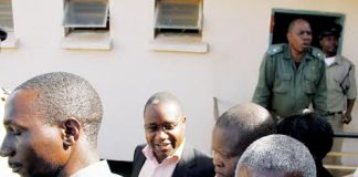 MMD Chisamba member of Parliament Moses Muteteka (background) is led to a waiting vehicle after he was sentenced to five years in prison with hard labour yesterday. – Picture by MACKSON WASAMUNU