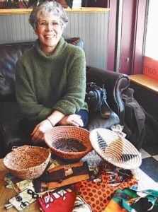 JOANNE BOLLINGER displays goods made at the Women’s Center sponsored by WISE in Kaoma, Zambia. ROSANNA GARGIULO : THE TIMES RECORD