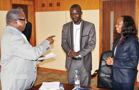 Kapeya (left) talks to National Association of Media Arts chairperson Patrick Salubusa and Zamcops general manager MutaleKaemba (right) at the signing of a memorandum of understanding in Lusaka yesterday. – Picture by UYOYA NDIMBA.jpg