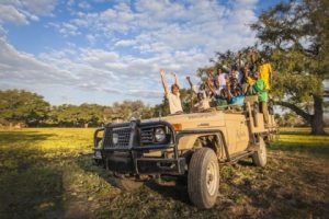 Mario Vos from Kafunta Safaris on a game drive with local children for Kids in the Wild. (Photograph by Marcus and Kate Westberg)