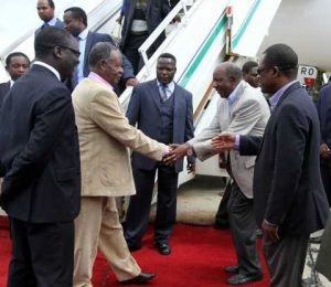 President Michael Sata greets Finance minister Alexander Chikwanda on arrival at Kenneth Kaunda International Airport -Picture by EDDIE MWANALEZA