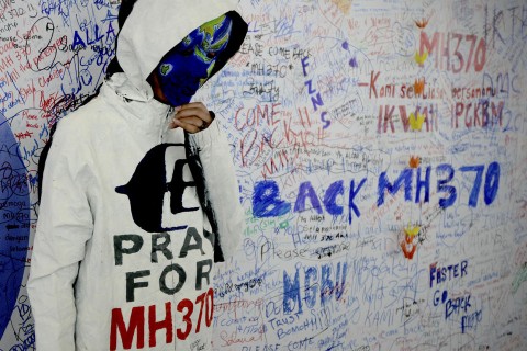 An unidentified woman with her face painted, depicting the flight of the missing Malaysia Airline, MH370