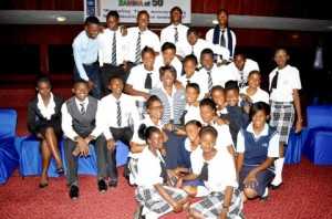 First Lady Dr Christine Kaseba pose for a photograph with Lusaka High School pupils during the First Lady's Mentorship programme at Mulungushi International Conference Centre on March 11,2014