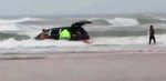 In this image made from video and released by Simon Besner, lifeguards rescue children from a minivan that their mother drove into the Atlantic Ocean, Tuesday, March 4, 2014 in Daytona Beach, Fla.