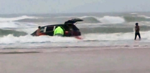 In this image made from video and released by Simon Besner, lifeguards rescue children from a minivan that their mother drove into the Atlantic Ocean, Tuesday, March 4, 2014 in Daytona Beach, Fla. In this image made from video and released by Simon Besner, lifeguards rescue children from a minivan that their mother drove into the Atlantic Ocean, Tuesday, March 4, 2014 in Daytona Beach, Fla.