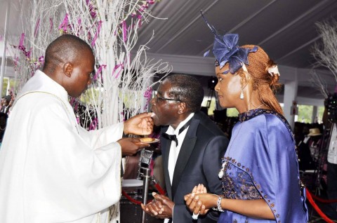 Zimbabwean President Robert Mugabe and First Lady Grace Mugabe with Fr Kennedy Muguti during the wedding ceremony of their daughter Bona Mugabe and her husband Simba at their residence in Harare