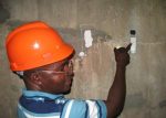 An engineer shows reporters cracks in the Kariba Dam wall last year