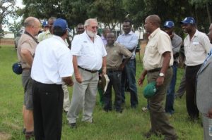 Commissioner of Prisons Percy K Chato listens to Saro Agro Equipment Technical Officer at the Saro Farms Field Day in Lusaka West.
