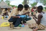 Community health volunteers test people for malaria in a village in Zambia in November 2012.