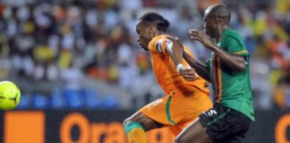 Hichani Himoonde of Zambia battles with Didier Drogba of Ivory Coast