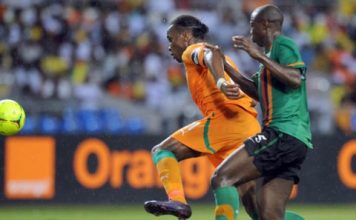 Hichani Himoonde of Zambia battles with Didier Drogba of Ivory Coast