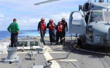 Sailors inspecting the flight deck of the Arleigh Burke-class destroyer USS Kidd (DDG 100) at sea in the Indian Ocean on March 16, while conducting search and rescue (SAR) operations for the missing Malaysian Airlines flight MH370