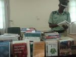 The Commander Training College Kapalu Luneta perusing through the book donation from Canada that was handed over to his institution.