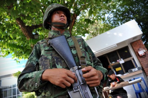 A Thai army soldier stands guard outside the National Broadcasting Services of Thailand
