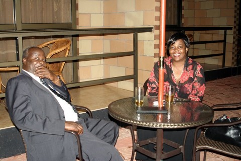 Lameck Mangani having a drink with former Lands Minister Judith kapijimpanga - Photo Credit - thepicturemonger