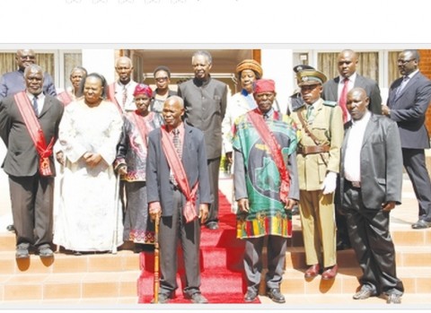 PRESIDENT Sata (centre back row) and acting Chief Justice Lombe Chibesakunda (second from left second row) pose honorees after the investiture ceremony at State House yesterday. – Picture by MACKSON WASAMUNU.