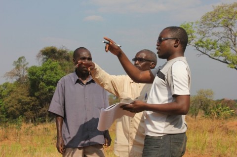 Paul Shalala (right) speaking with farmers as part of his investigation into the impact of mining on local residents