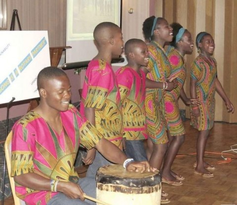 Performing various songs they've learned in class, Eustis, left, Eric, Frederick, Bertha, Dinas and Vivian, school children from Kitwe, Zambia, enjoy showcasing what they've learned. Performing various songs they've learned in class, Eustis, left, Eric, Frederick, Bertha, Dinas and Vivian, school children from Kitwe, Zambia, enjoy showcasing what they've learned.
