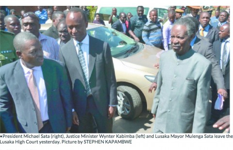 President Michael Sata (right), Justice Minister Wynter Kabimba (left) and Lusaka Mayor Mulenga Sata leave the Lusaka High Court yesterday. Picture by STEPHEN KAPAMBWE