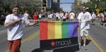 In this June 8, 2014, photo, workers carry a Macy’s banner during the gay pride parade, in Salt Lake City. (AP Photo:Rick Bowmer)