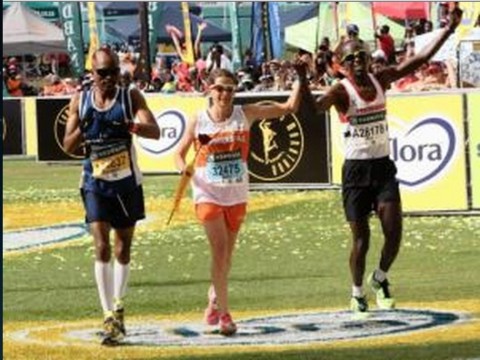 Zola Budd is escorted over the line by Bongani Possa, left, and Ken Mwapa of Zambia after finishing the Comrades Marathon. Photo- Sibonelo Ngcobo Zola Budd is escorted over the line by Bongani Possa, left, and Ken Mwapa of Zambia after finishing the Comrades Marathon. Photo- Sibonelo Ngcobo